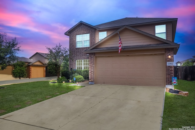 front facade with a yard and a garage