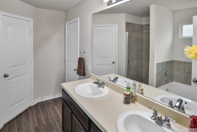 bathroom featuring vanity, wood-type flooring, and shower with separate bathtub