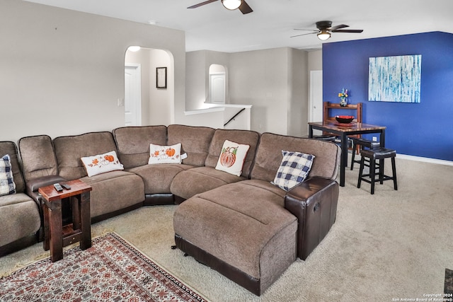 carpeted living room with ceiling fan