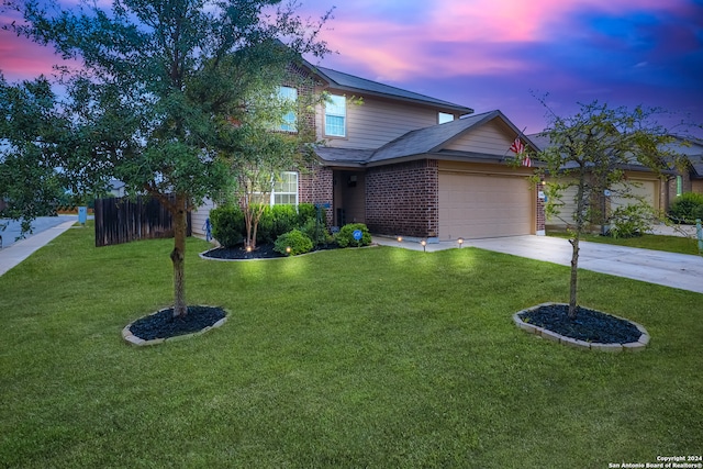 view of front of property featuring a garage and a lawn