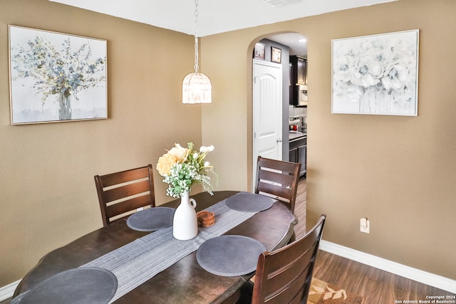 dining space featuring dark wood-type flooring