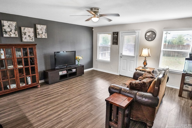 living room with dark wood-type flooring and ceiling fan