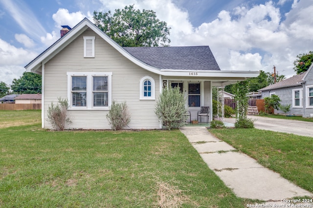 bungalow-style home with covered porch and a front lawn