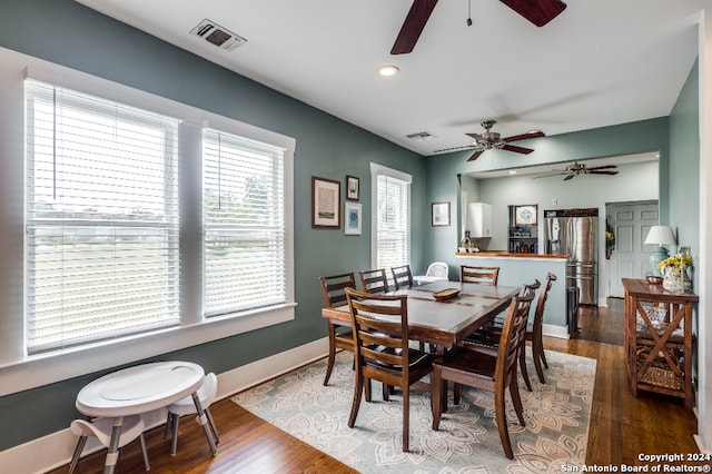 dining area with a wealth of natural light, dark wood-type flooring, and ceiling fan