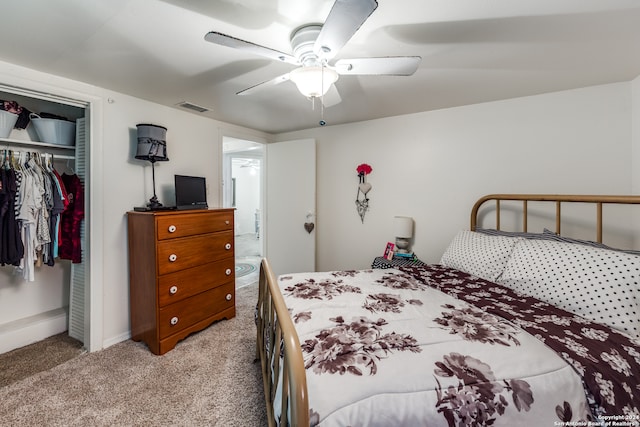 bedroom with a closet, ceiling fan, and light carpet