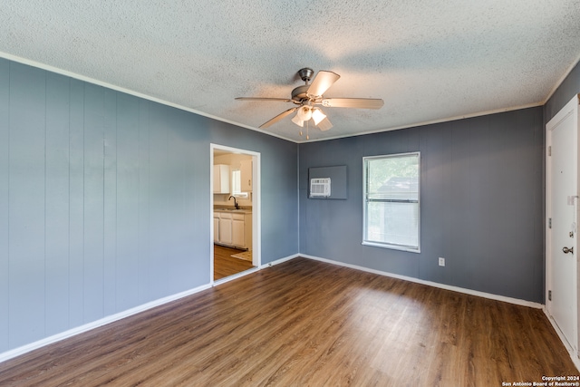 spare room featuring a textured ceiling, ceiling fan, sink, and wood-type flooring