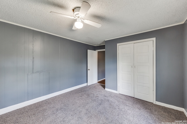 unfurnished bedroom featuring a textured ceiling, ceiling fan, a closet, and carpet floors