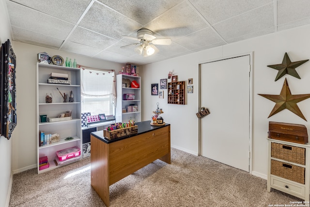 office space featuring light carpet, a paneled ceiling, and ceiling fan