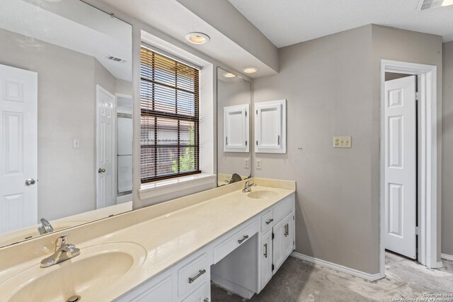 bathroom featuring concrete flooring and vanity