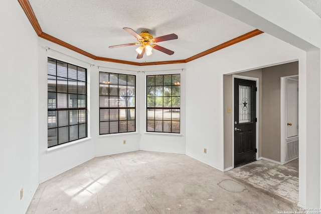 empty room featuring ceiling fan, ornamental molding, and a textured ceiling