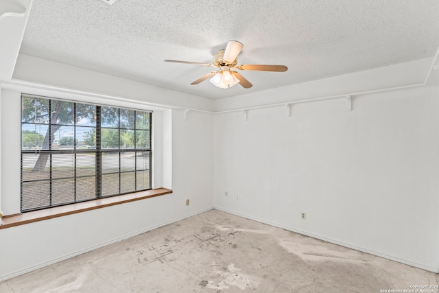 spare room featuring a textured ceiling and ceiling fan