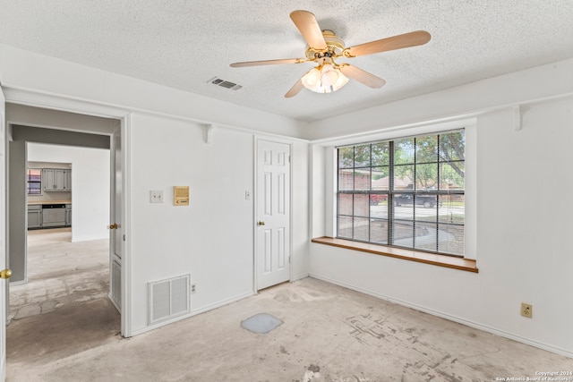 spare room with ceiling fan and a textured ceiling