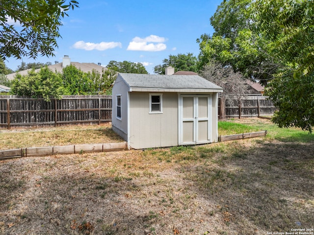 view of outbuilding with a yard