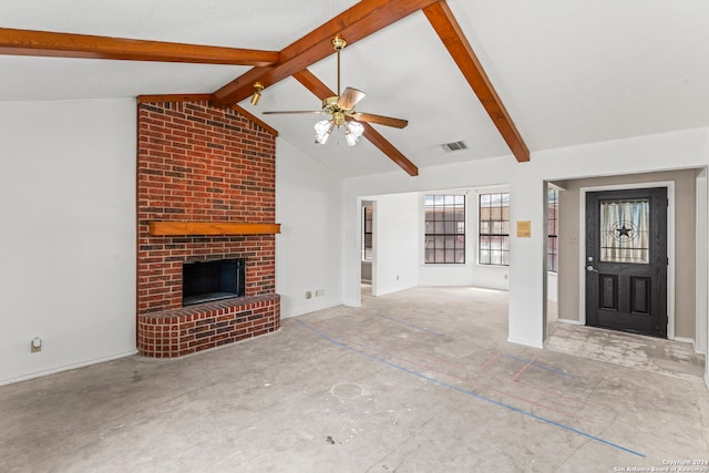 unfurnished living room with a fireplace, lofted ceiling with beams, and ceiling fan