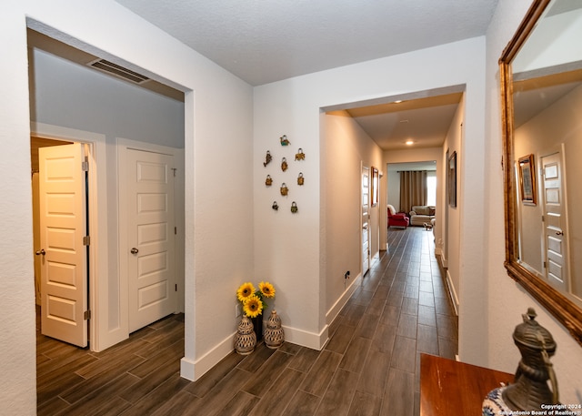 corridor with dark wood-type flooring