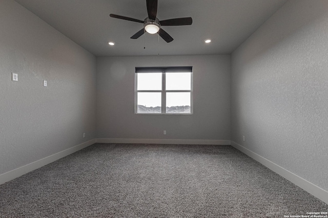 unfurnished room featuring carpet floors, a textured wall, ceiling fan, and baseboards