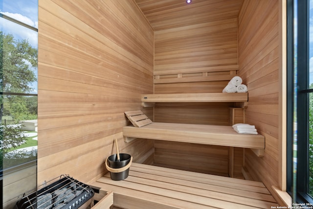 view of sauna with wood walls and wooden ceiling