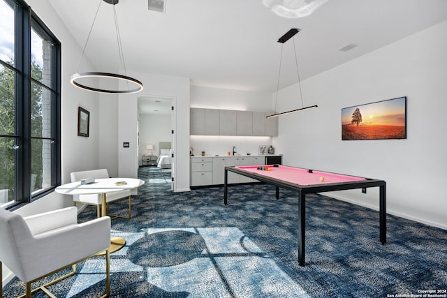 game room with a wealth of natural light, dark carpet, and pool table