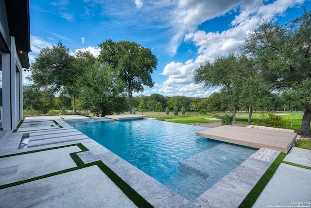 view of swimming pool featuring a patio area