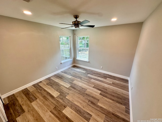 empty room with light hardwood / wood-style flooring and ceiling fan