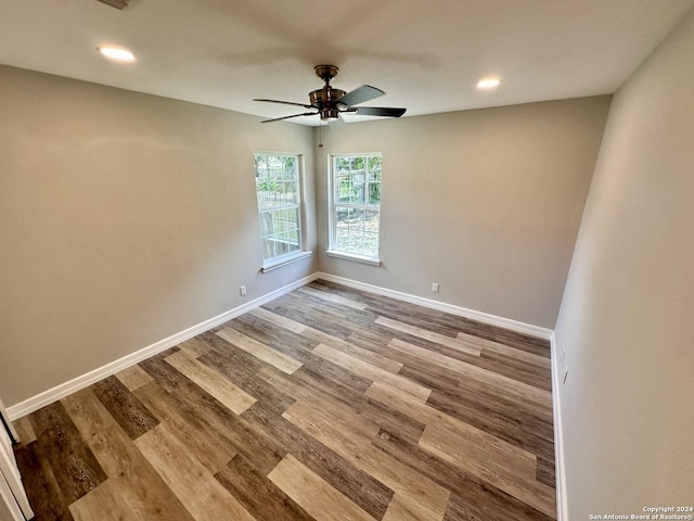 spare room featuring recessed lighting, a ceiling fan, baseboards, and wood finished floors