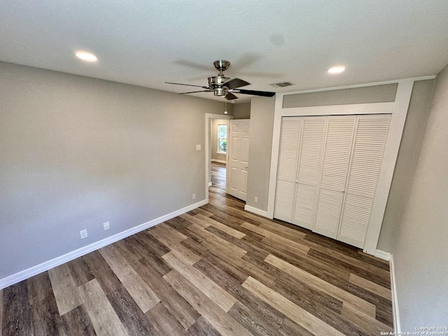 unfurnished bedroom with visible vents, baseboards, recessed lighting, wood finished floors, and a closet