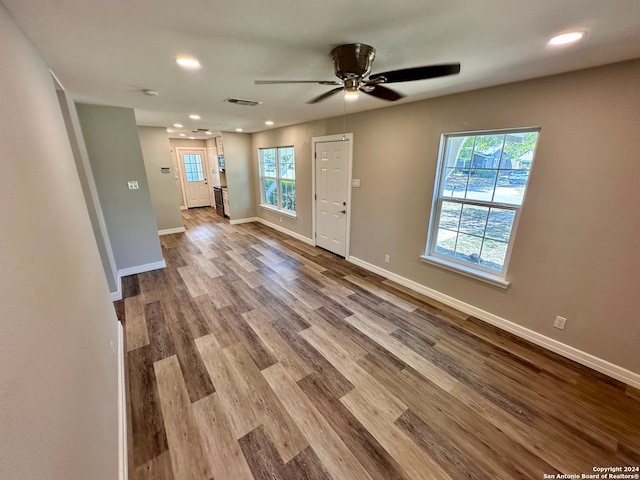 unfurnished living room with ceiling fan and light hardwood / wood-style flooring