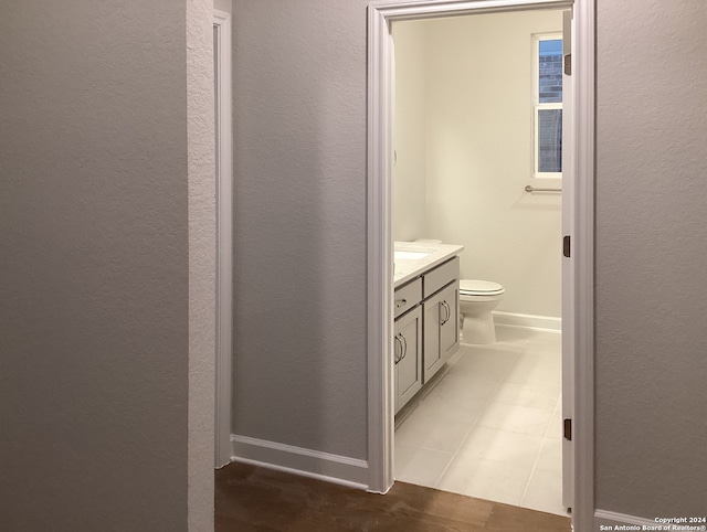 bathroom featuring toilet, vanity, and tile patterned floors