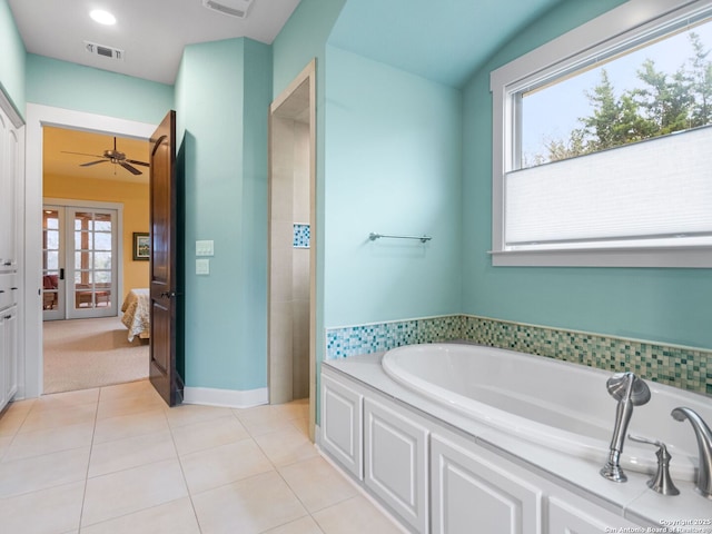 ensuite bathroom featuring ensuite bathroom, a garden tub, visible vents, french doors, and tile patterned floors