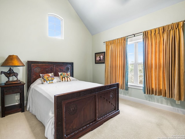 bedroom with baseboards, vaulted ceiling, and light colored carpet