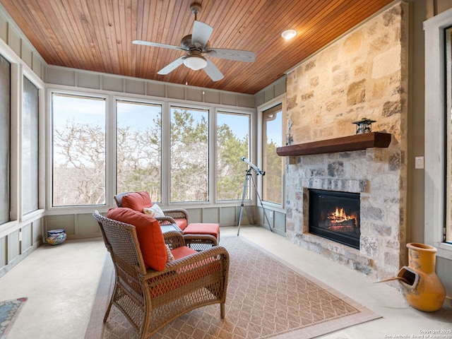 living area with wooden ceiling, a decorative wall, and a sunroom