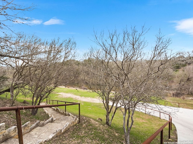 view of yard with a rural view and fence