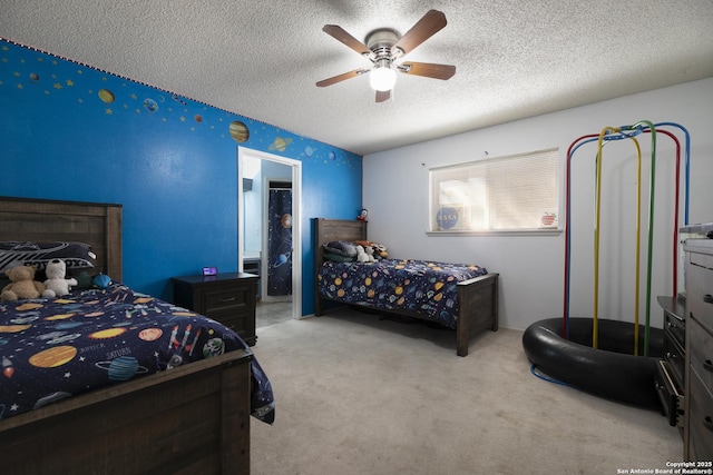 carpeted bedroom featuring a textured ceiling and ceiling fan