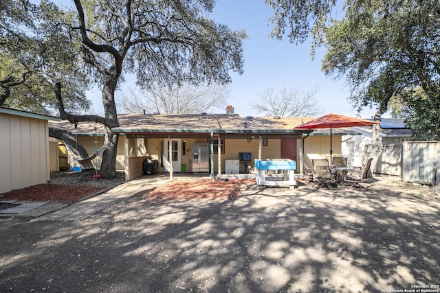 rear view of property with a patio area and fence