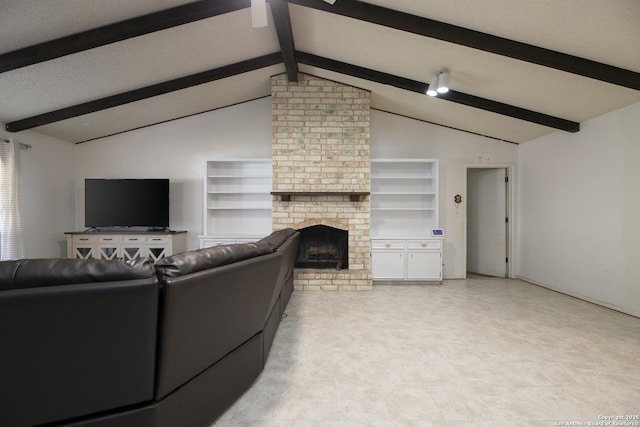 living area with lofted ceiling with beams, a textured ceiling, and a fireplace