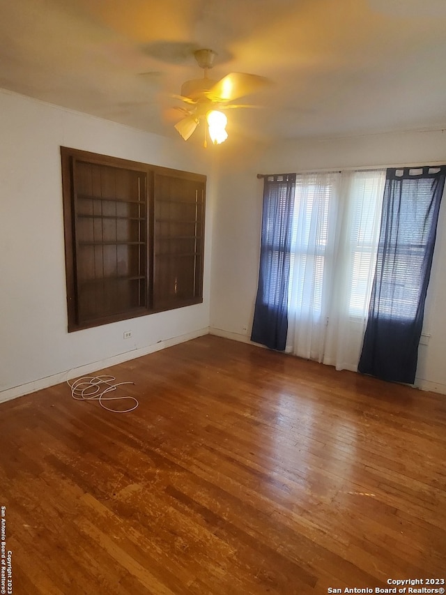 empty room featuring ceiling fan and hardwood / wood-style flooring