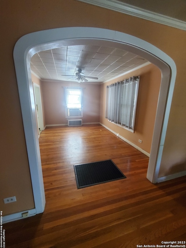 spare room with ceiling fan, ornamental molding, and hardwood / wood-style flooring