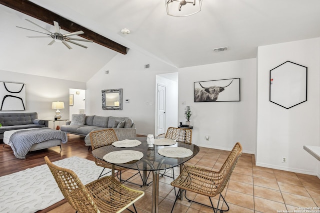 interior space featuring vaulted ceiling with beams and light tile patterned flooring