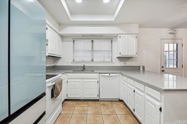 kitchen featuring white cabinets, white appliances, light tile patterned floors, and kitchen peninsula