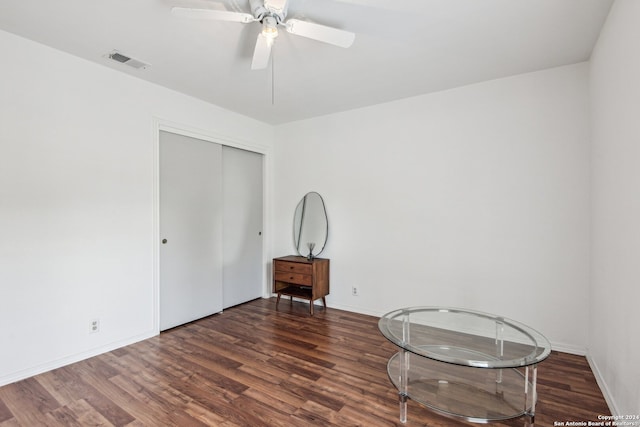 interior space with dark wood-type flooring and ceiling fan