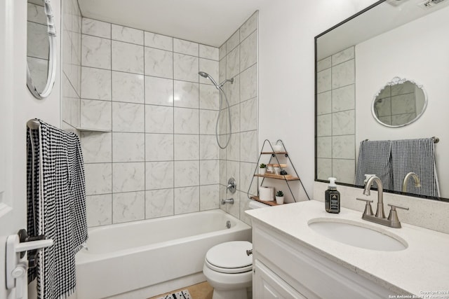 full bathroom with tiled shower / bath, toilet, and vanity