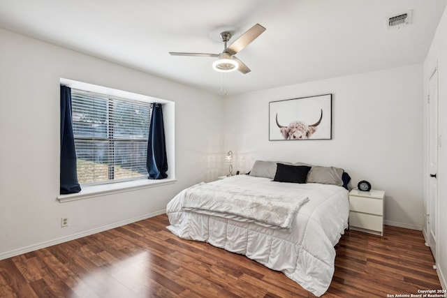 bedroom with dark wood-type flooring and ceiling fan