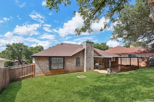 back of house featuring a yard and a patio