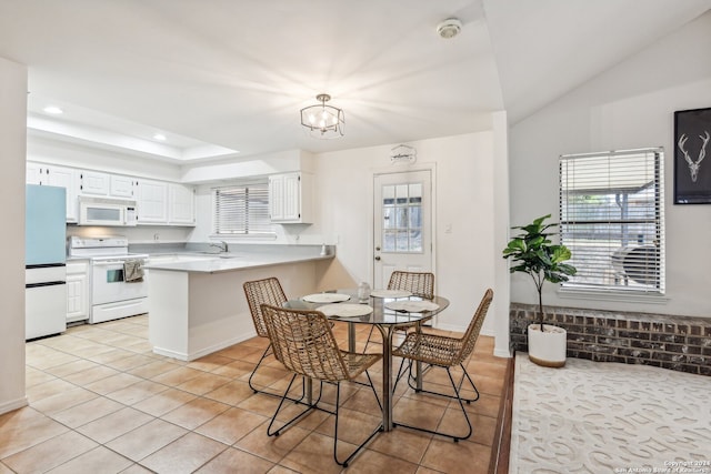 dining area with sink, an inviting chandelier, and light tile patterned flooring