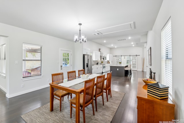 dining room featuring dark hardwood / wood-style floors and a barn door