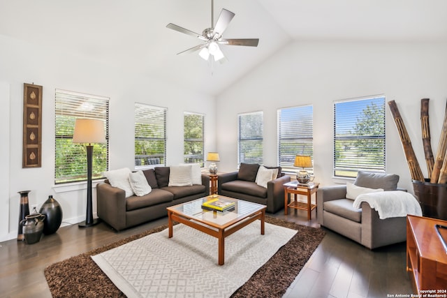 living room with ceiling fan, high vaulted ceiling, a healthy amount of sunlight, and dark hardwood / wood-style floors