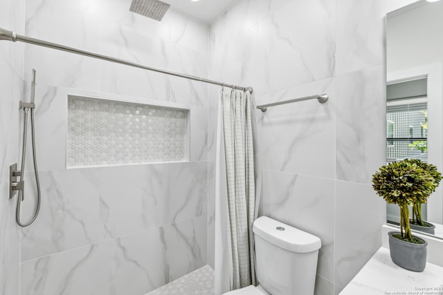 bathroom featuring curtained shower and toilet