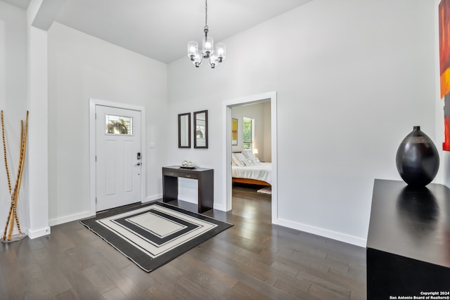 entrance foyer featuring an inviting chandelier and dark hardwood / wood-style flooring