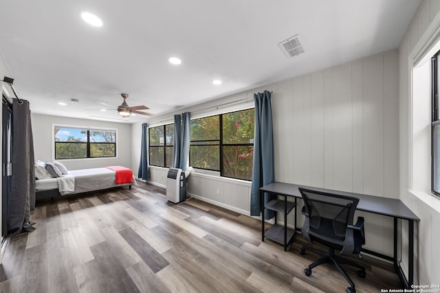 bedroom with hardwood / wood-style floors and ceiling fan