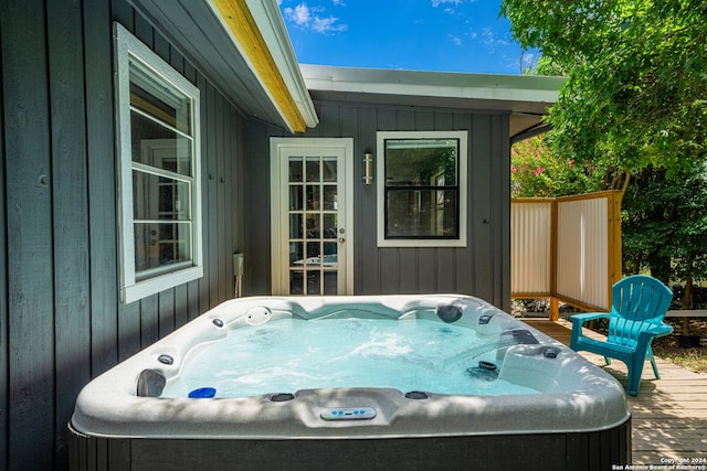 view of patio featuring a hot tub and a deck